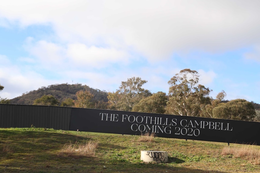 Signage on hoarding around the development site reads 'The Foothills Campbell coming 2020'.
