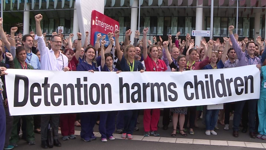 Doctors from the Royal Children's Hospital in Melbourne raise their fists against detention.