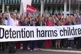 Doctors from the Royal Children's Hospital in Melbourne raise their fists against detention.
