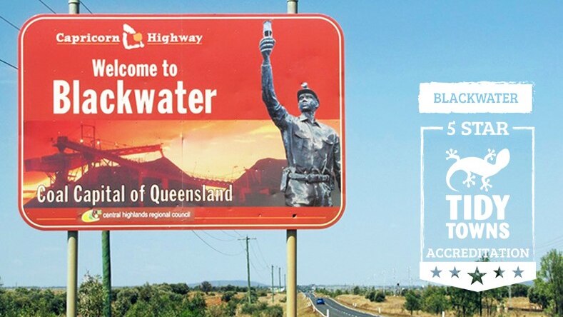 A sign on the side of the Capricorn Highway reads "Welcome to Blackwater Coal Capital of Queensland"