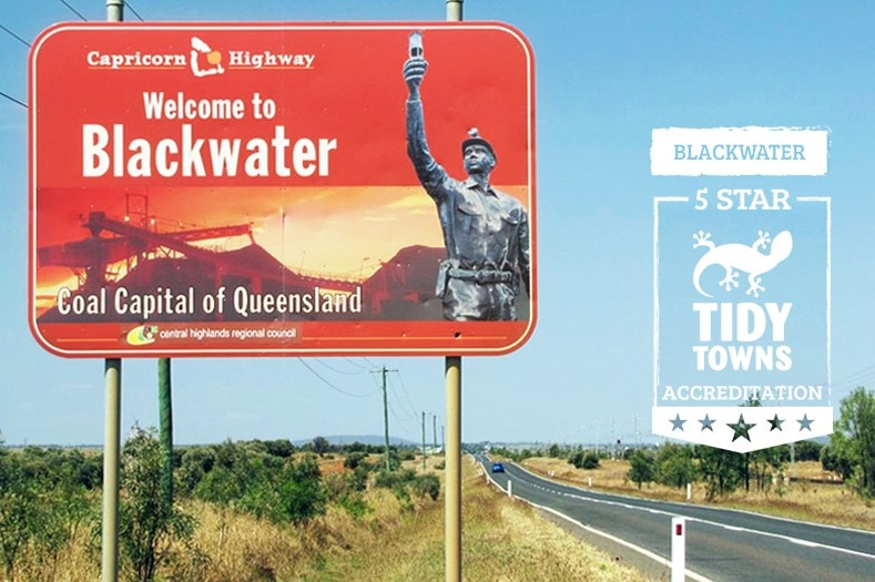 A sign on the side of the Capricorn Highway reads "Welcome to Blackwater Coal Capital of Queensland"