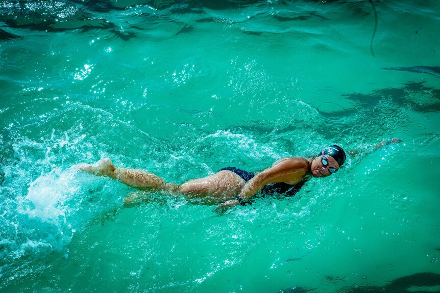 A woman swims laps