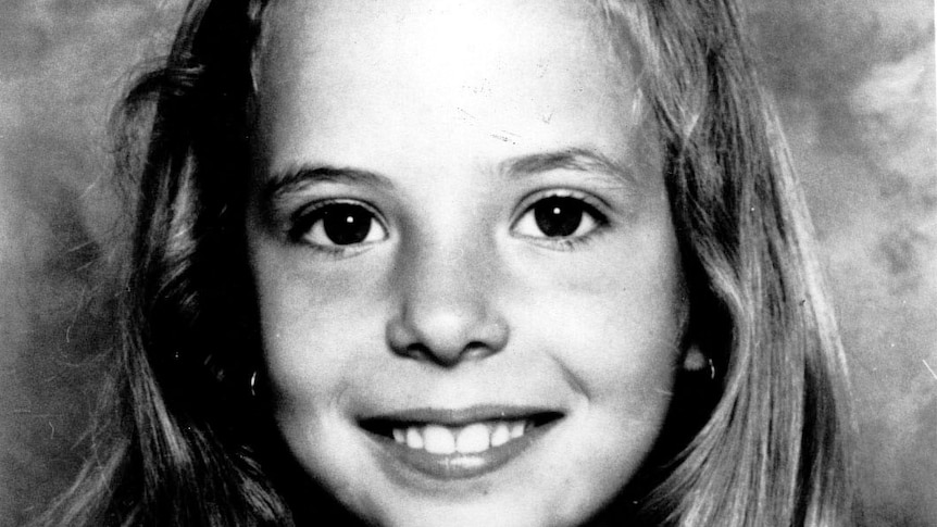 A black and white portrait of a young girl.