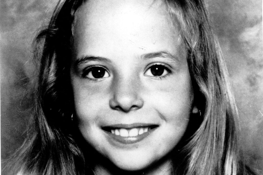 A black and white portrait of a young girl.