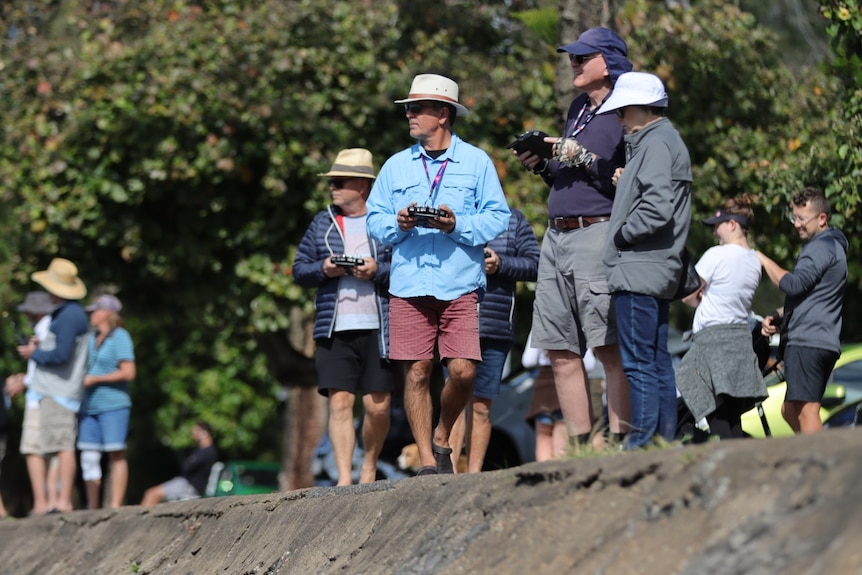 Members of the Wynnum Manly radio controlled model yacht club racing their craft