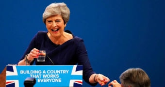 Britain's Chancellor of the Exchequer hands a cough lolly to Prime Minister Theresa May