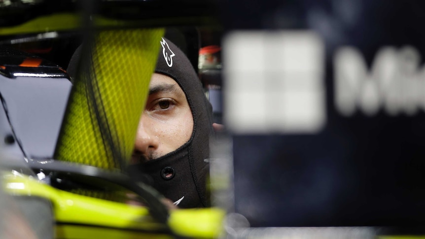 Daniel Ricciardo sits in his F1 car, partially obscured by the halo device.