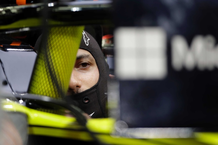 Daniel Ricciardo sits in his F1 car, partially obscured by the halo device.