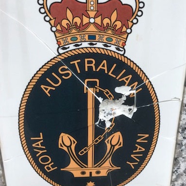 A cracked and broken Royal Navy tile on the war memorial at Sunshine.