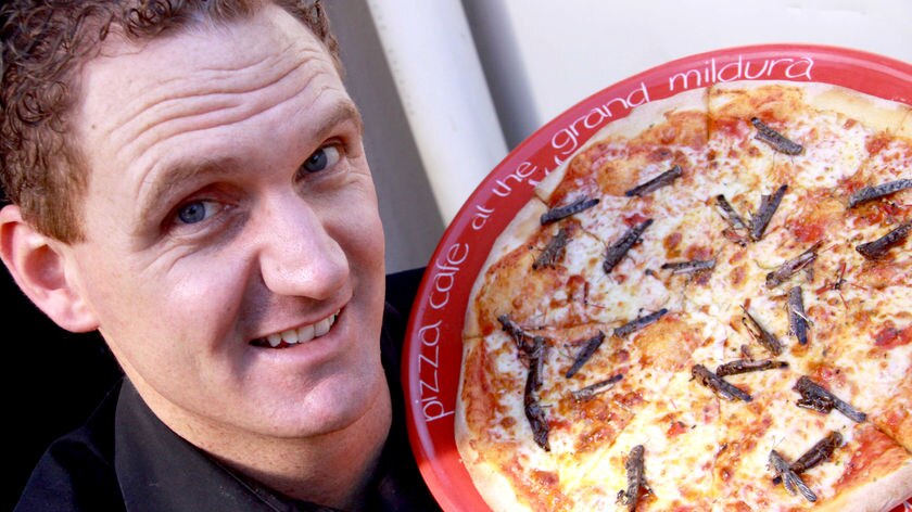 Joe Carrazza with his locust pizza
