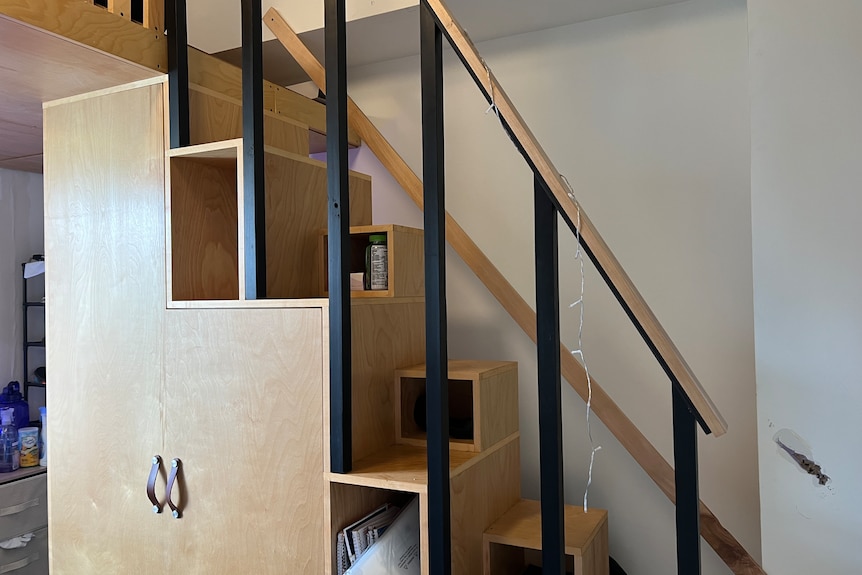 a steep set of stairs with storage built in