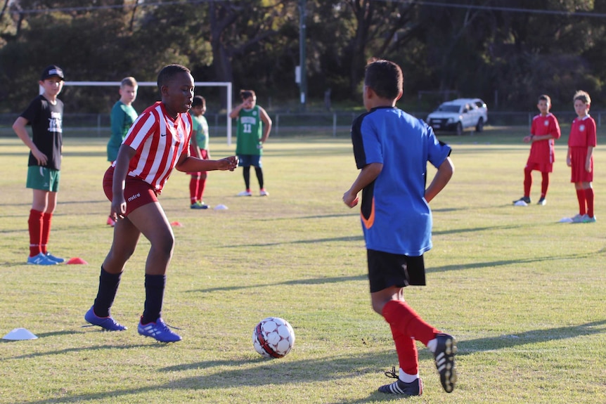 A group of children take part in a soccer training session