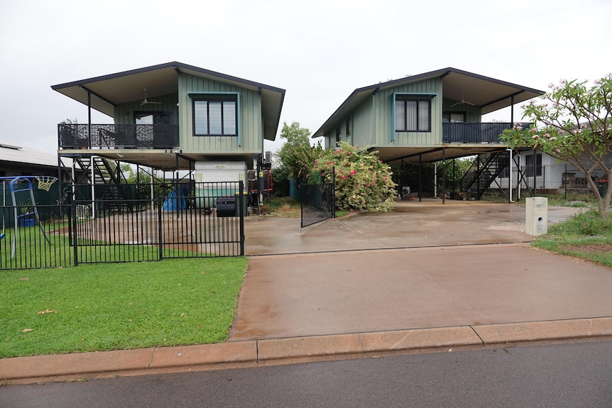 A pair of elevated houses, on blocks side by side, in Darwin. 