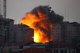 A ball of fire rises from a building following an Israeli air strike in Gaza City