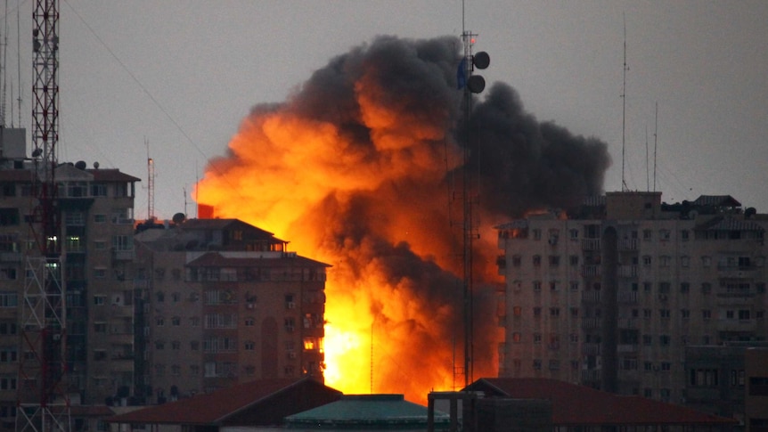 A ball of fire rises from a building following an Israeli air strike in Gaza City