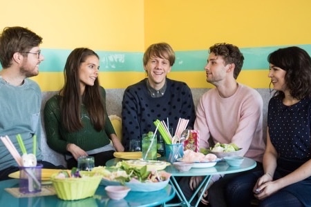 Tom sits left with Caitlin Stasey middle, Josh Thomas centre, Keegan Joyce right and Emily Barclay far right. 