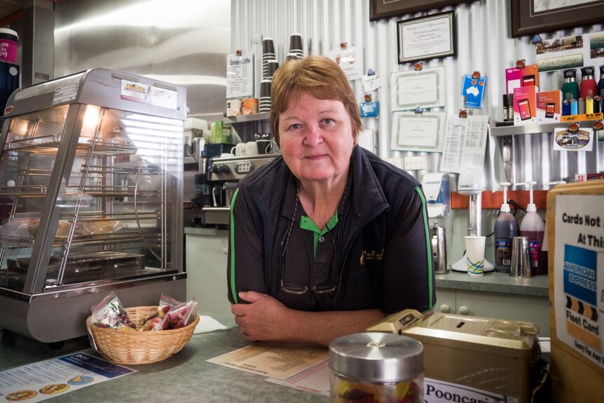 Pooncarie General Store owner Val Kitson leaning over the counter.
