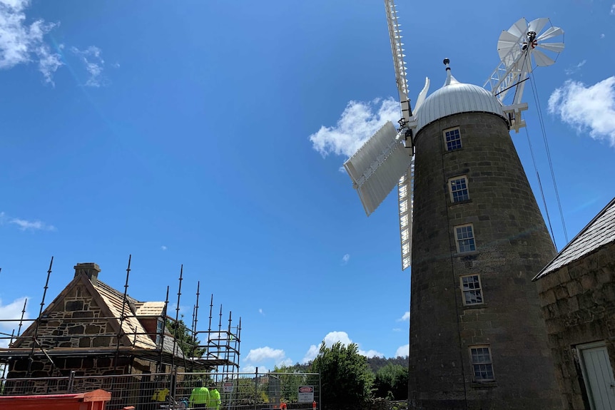 Old Miller's Cottage under renovation and windmill in Oatlands, Tasmania