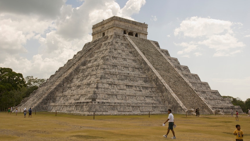 People walk around El Castillo at Chichen Itza in Mexico.