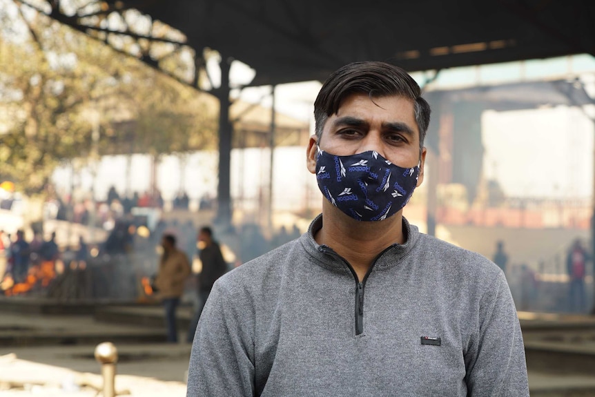 An Indian man in a face mask