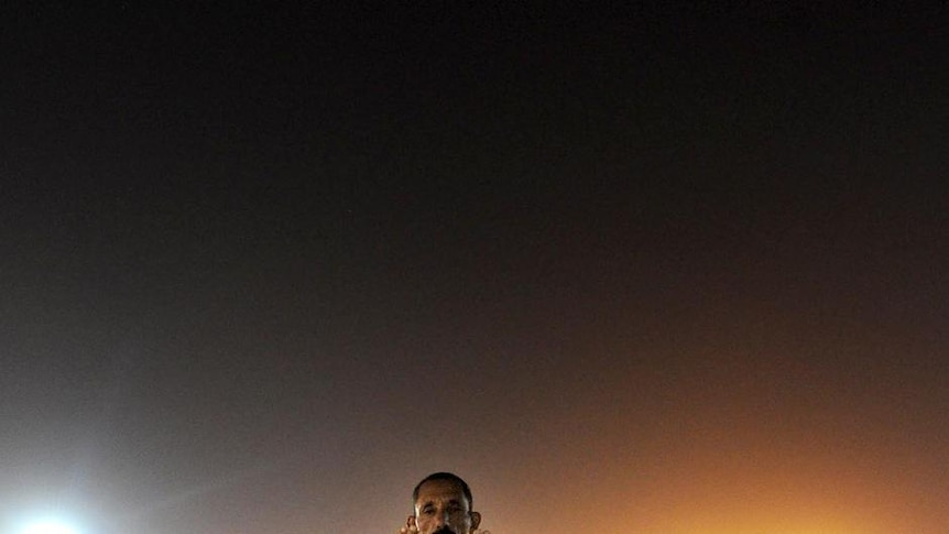 A Muslim pilgrim prays at Mount Arafat