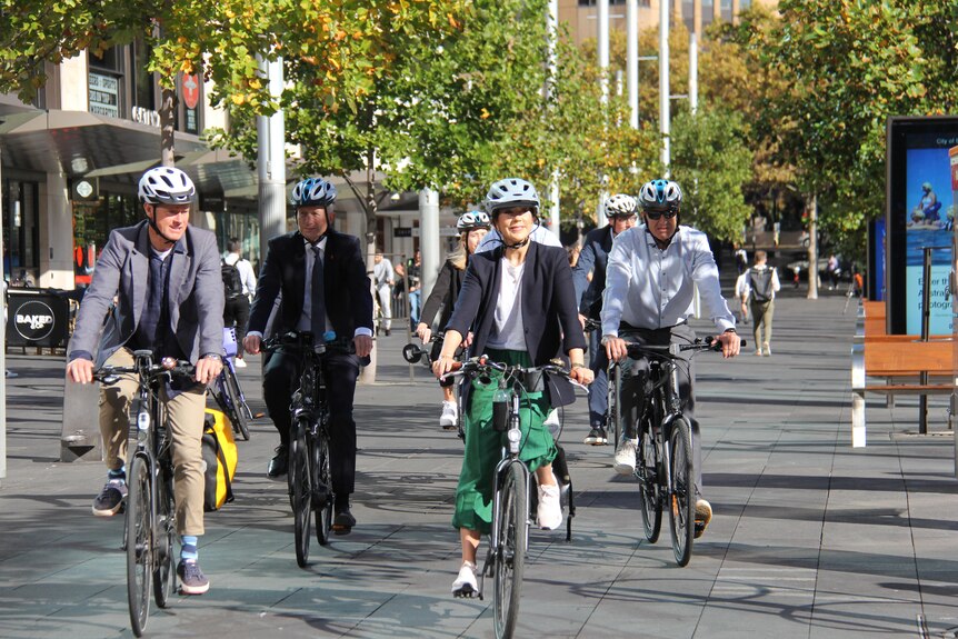 A group of people riding bikes