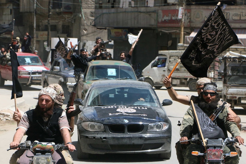 Fighters from Al Qaeda's Syrian affiliate Al-Nusra Front drive in the northern Syrian city of Aleppo