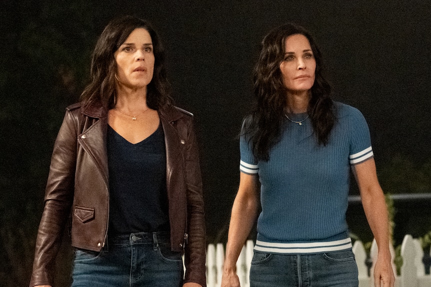 Two middle-aged women with dark hair appear distressed as they look at something offscreen