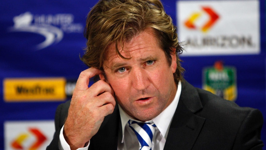 Des Hasler addresses the media after a game