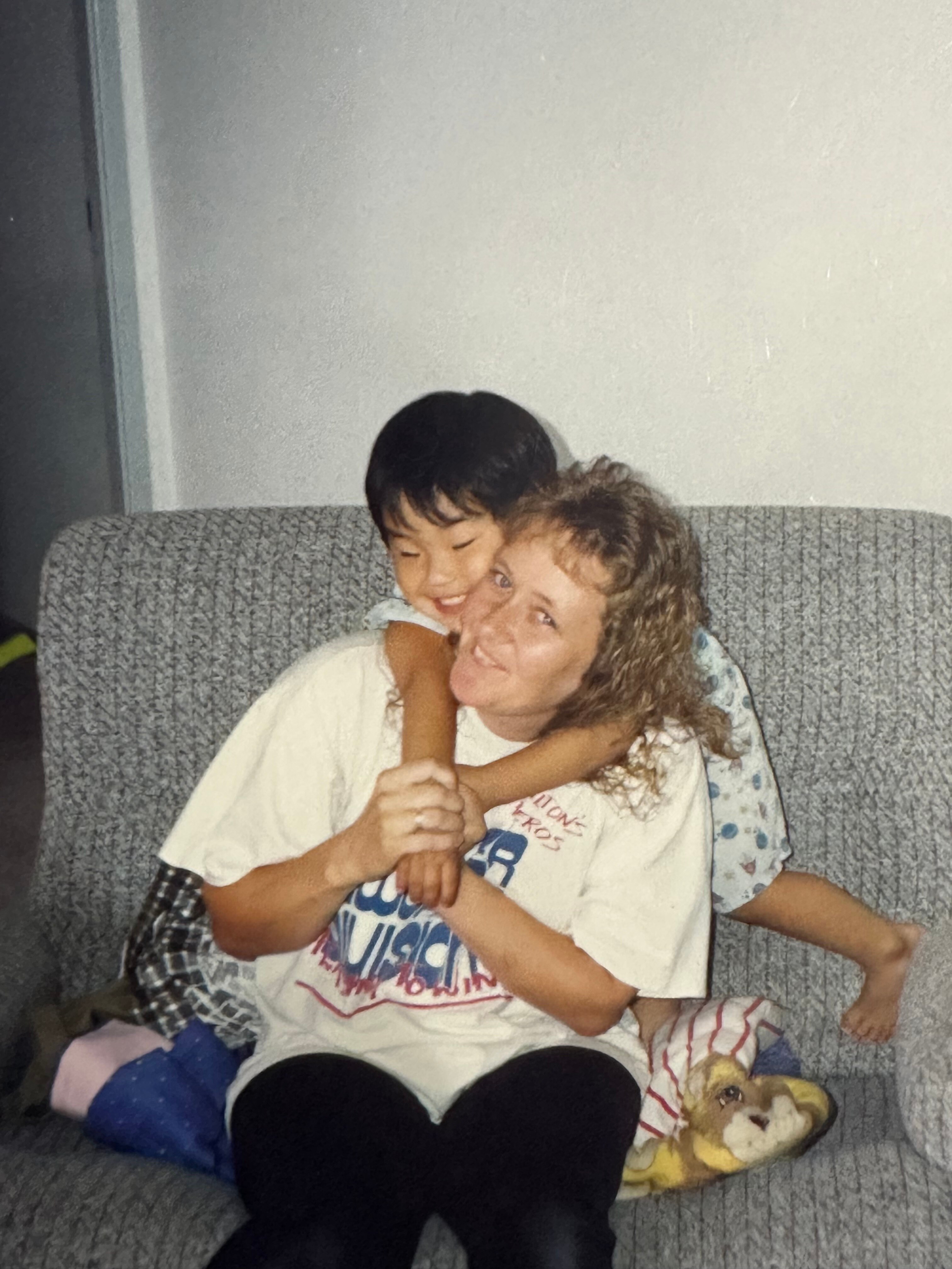 Matt Purcell as a child hugging his mother.