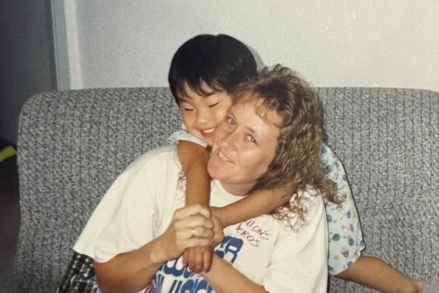 Matt Purcell as a child hugging his mother.