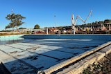 empty pool in front of construction site