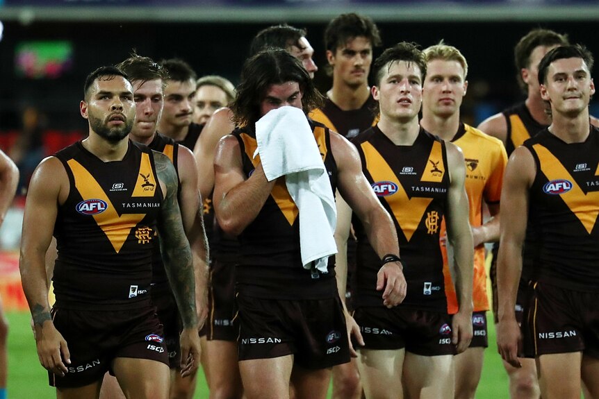 Hawthorn players leave the ground