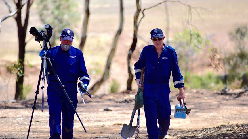Forensic officers from Victoria Police investigate the discovery of a body in bushland at Shelbourne near Bendigo