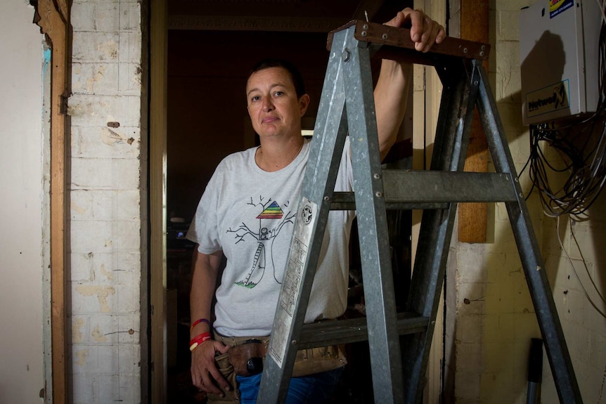 Simone Curry stands next to a ladder