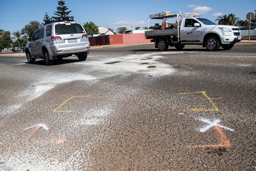 Chalk outlines on the road where the two cars collided.