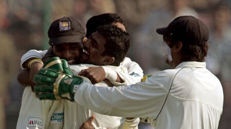 Muttiah Muralitharan celebrates with team-mates on day two of second Test v India in New Delhi