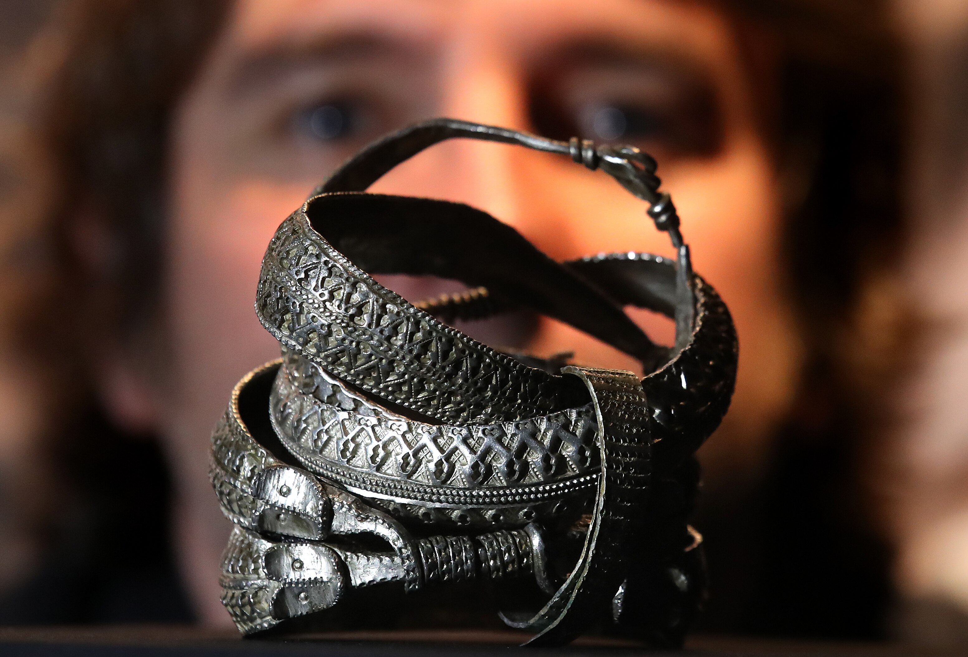 A pile of tarnished decorative silver armbands