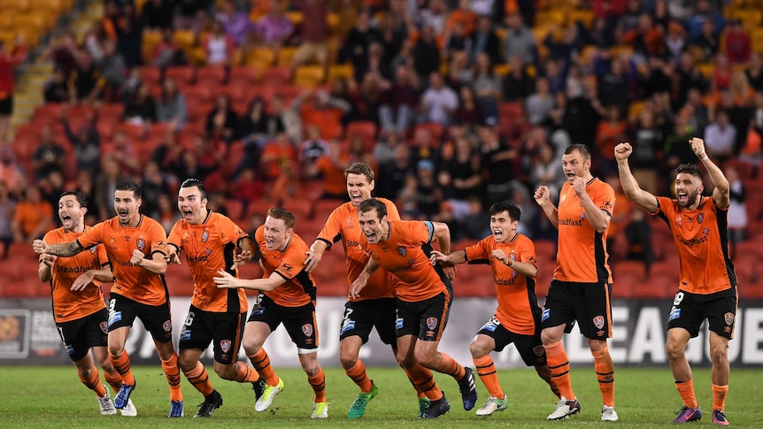Brisbane Roar players celebrate their penalty-shootout win