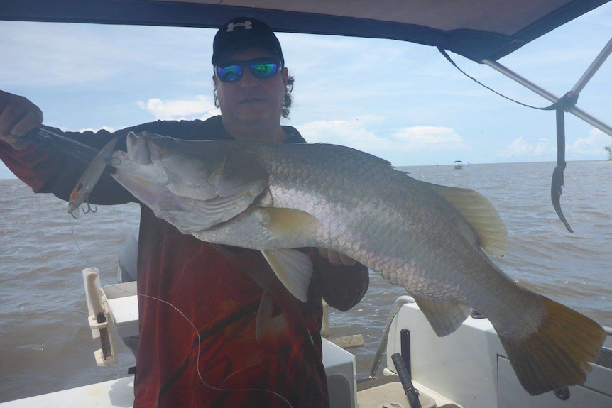 Peter Davis displays a big fish he caught.