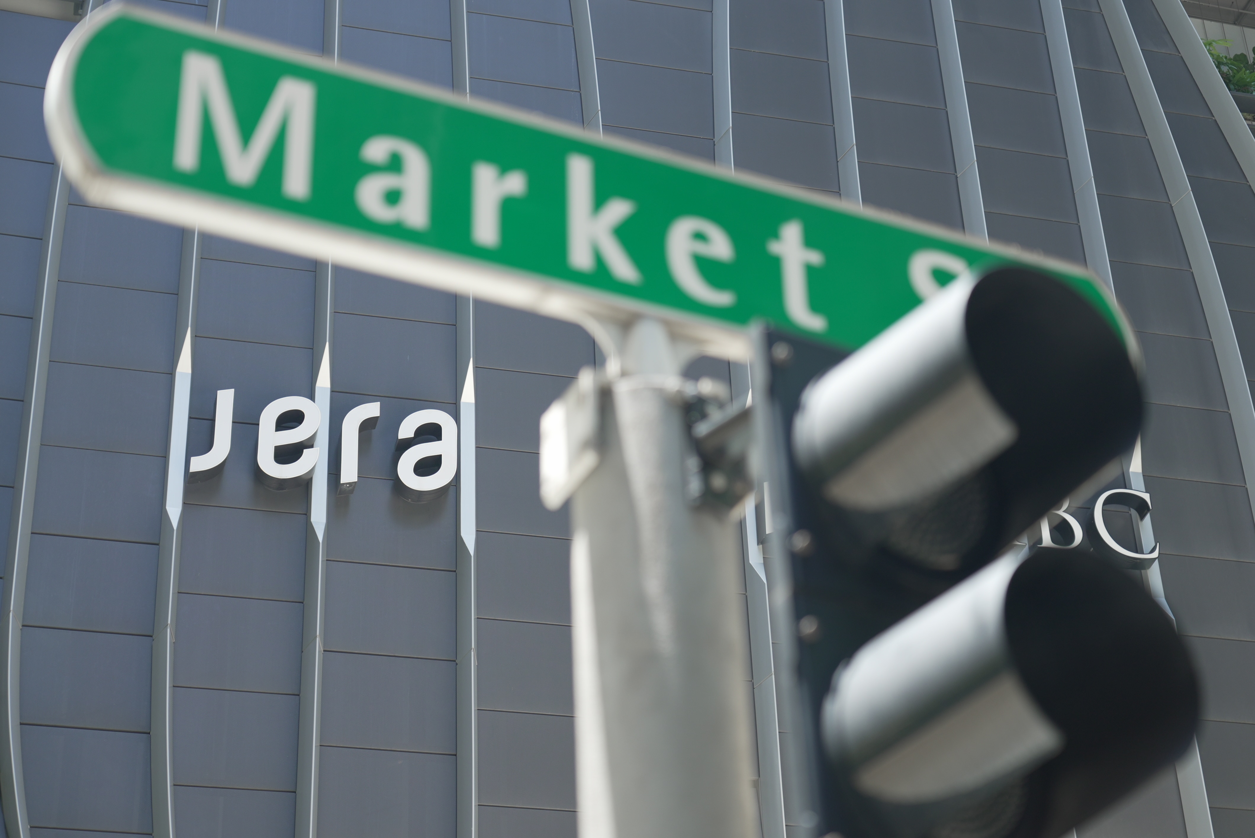 A street sign in front of a tall building