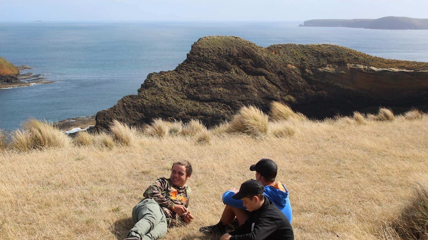 Aboriginal boys in Tasmania sit at taynayuwa
