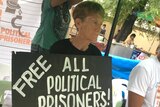 Patricia Fox is carrying a sign that reads "free all political prisoners".