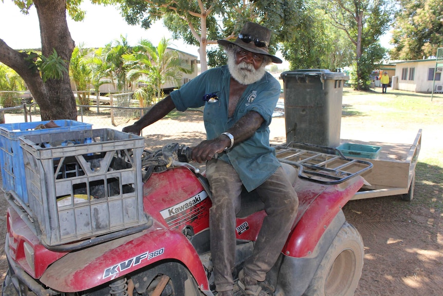 Gardener Phillip Beasley sitting on a quad bike in the shade of a tree at the Delta Downs homestead.