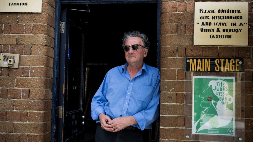 Louis Nowra leans against the doorway at the entrance of the Old Fitzroy Hotel