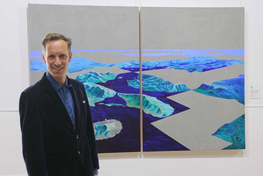 Glover Prize winner Piers Greville standing next to his winning artwork Pedder Prime Cuts, March 2019.