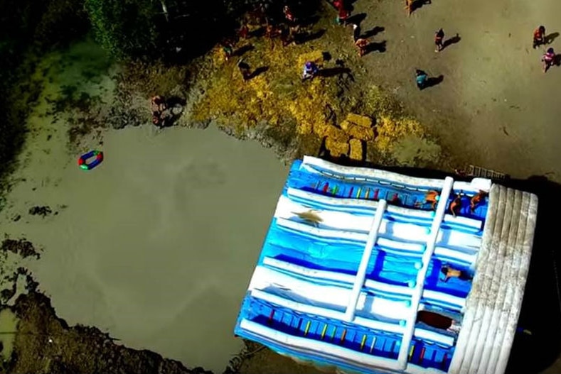 Aerial view of giant five lane waterslide on top of lake edge