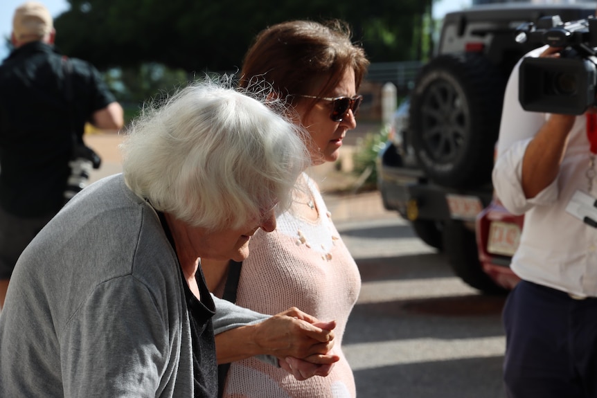 A woman walks from court with her mother after giving evidence at a trial.