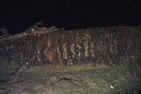 A close up of the rusted russian vessel in the ocean.