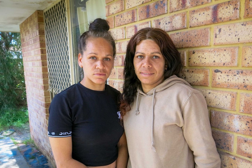 Hayley, left, and Margaret, right, standing against the wall of the house they have now moved into.